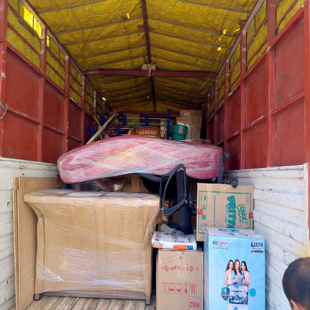 Team loading boxes into moving truck